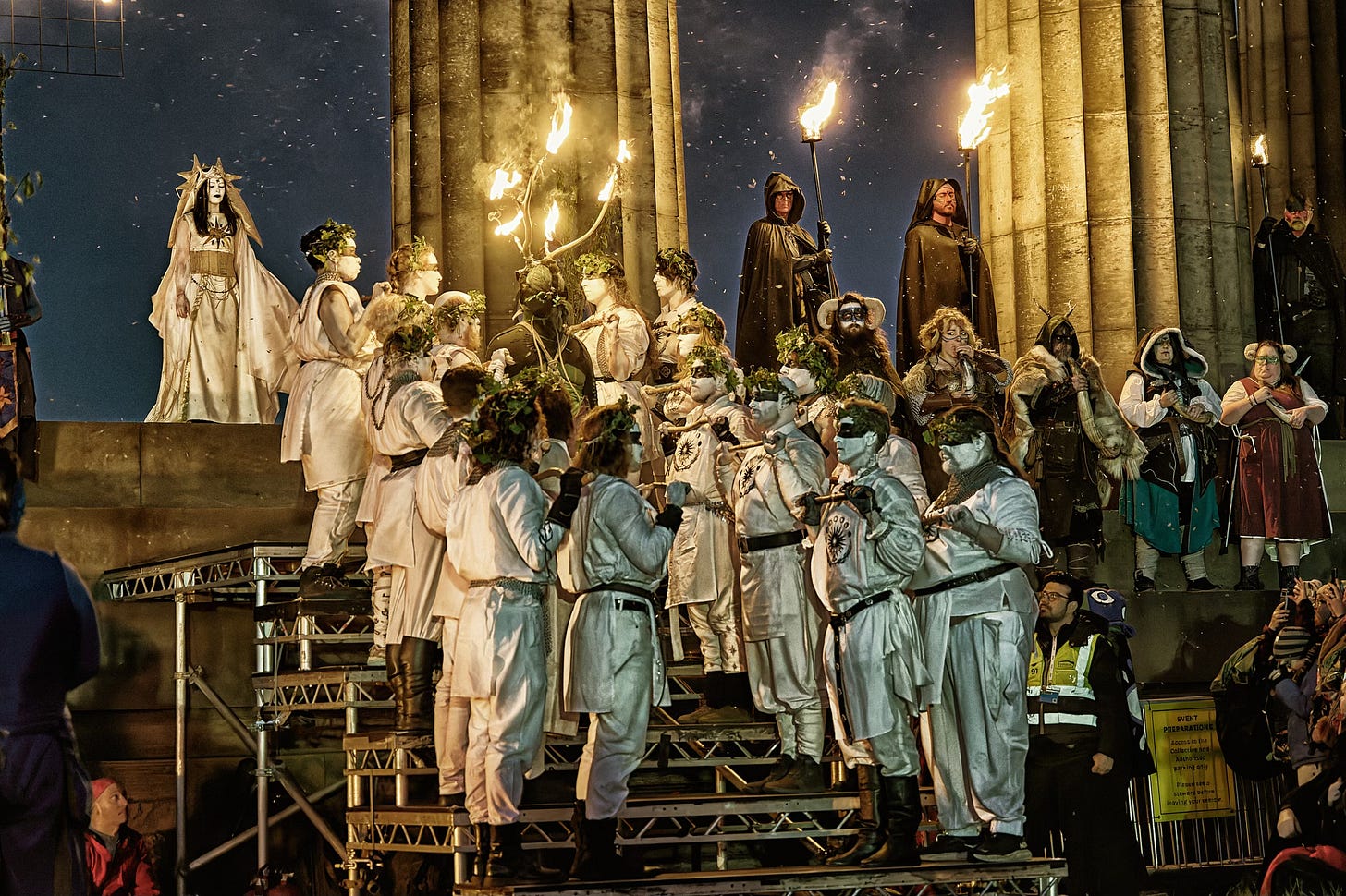 The Edinburgh Beltane Fire Festival on Calton Hill is inspired by ancient Celtic seasonal rituals. This documentary fieldwork photograph is of the Winter Green Man ascending the Acropolis steps to meet the May Queen.