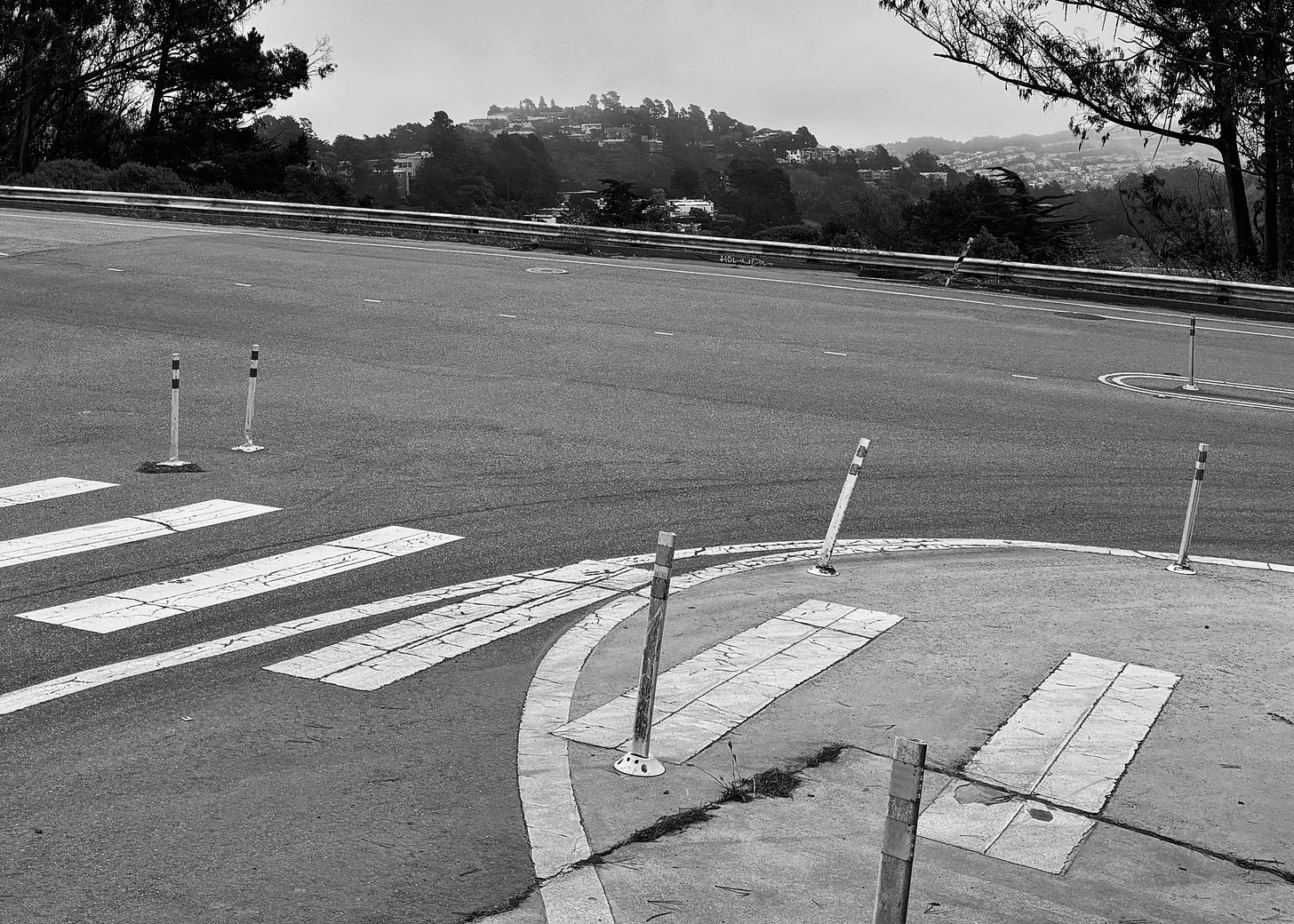 A road with vertical poles, some straight and some not