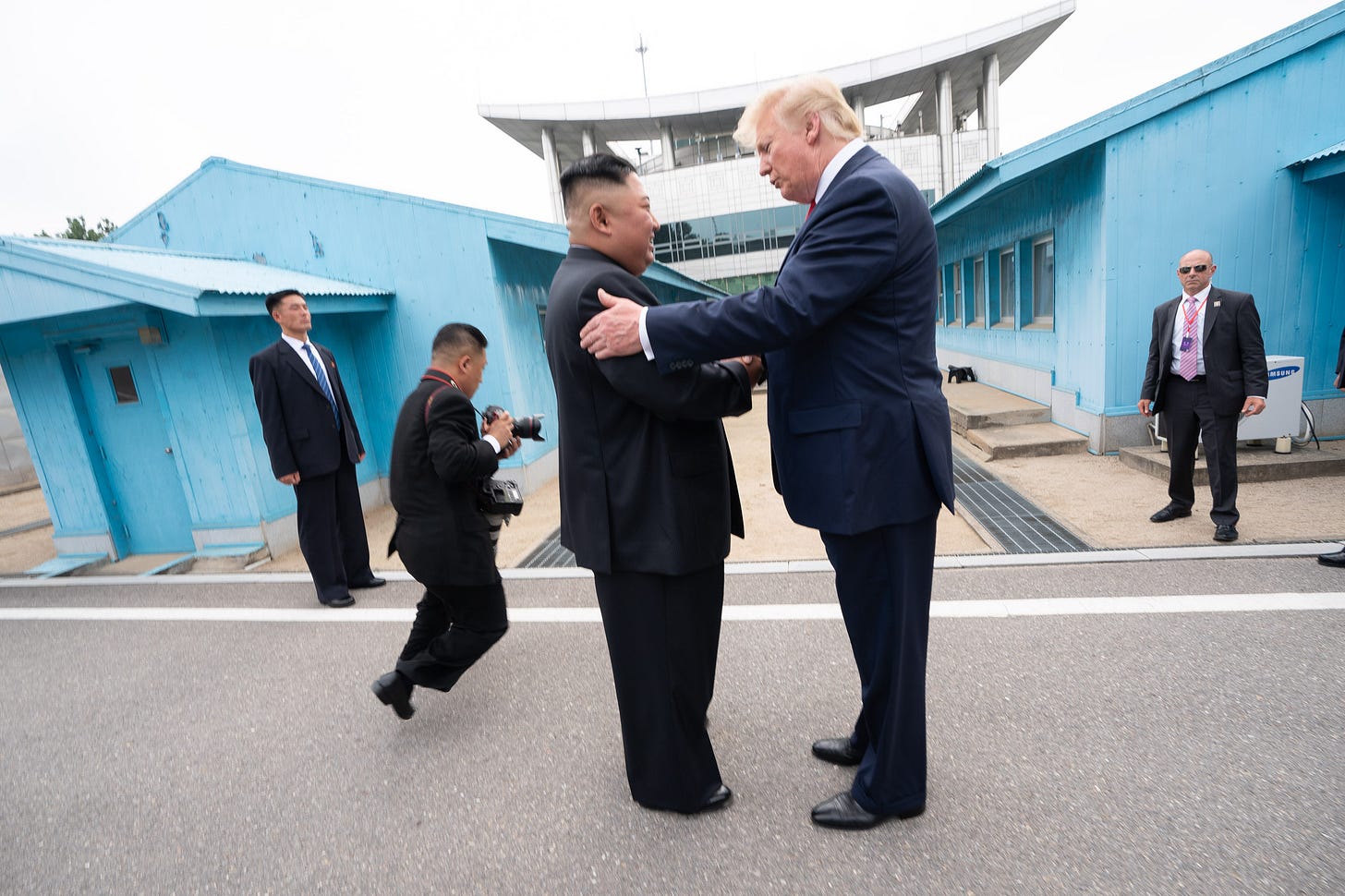 Donald Trump and Kim Jong Un shake hands at the inter-Korean border during their June 2019 meeting.
