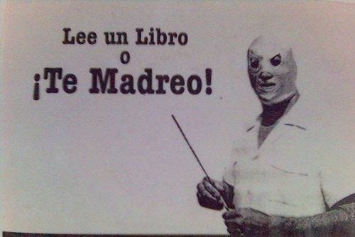 This may contain: a man holding a stick in front of a sign that says lee un libro o'te madro This may contain: a man holding a stick in front of a sign that says lee un libro o'te madro