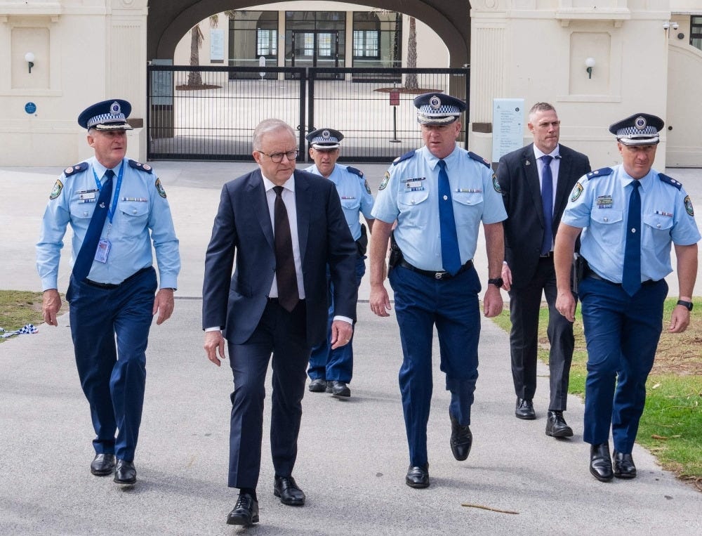 A handout photo taken and released by the Australian Prime Minister's Office on December 15, 2025 shows Australia's Prime Minister Anthony Albanese (2nd left) walking with police officers after laying flowers at the Bondi Pavillion at Bondi Beach, the scene of a shooting where 15 people were killed. — Australian Prime Minister's Office handout/AFP pic 