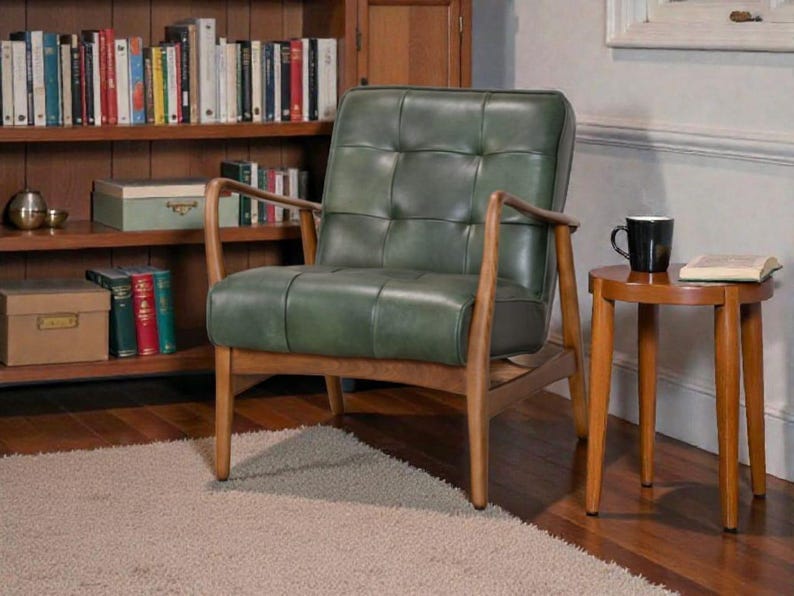 May include: An armchair featuring a tufted dark green leather seat and backrest with a wooden frame. The chair has curved wooden armrests and four tapered legs. The seat and back are constructed with a grid of square cushions.