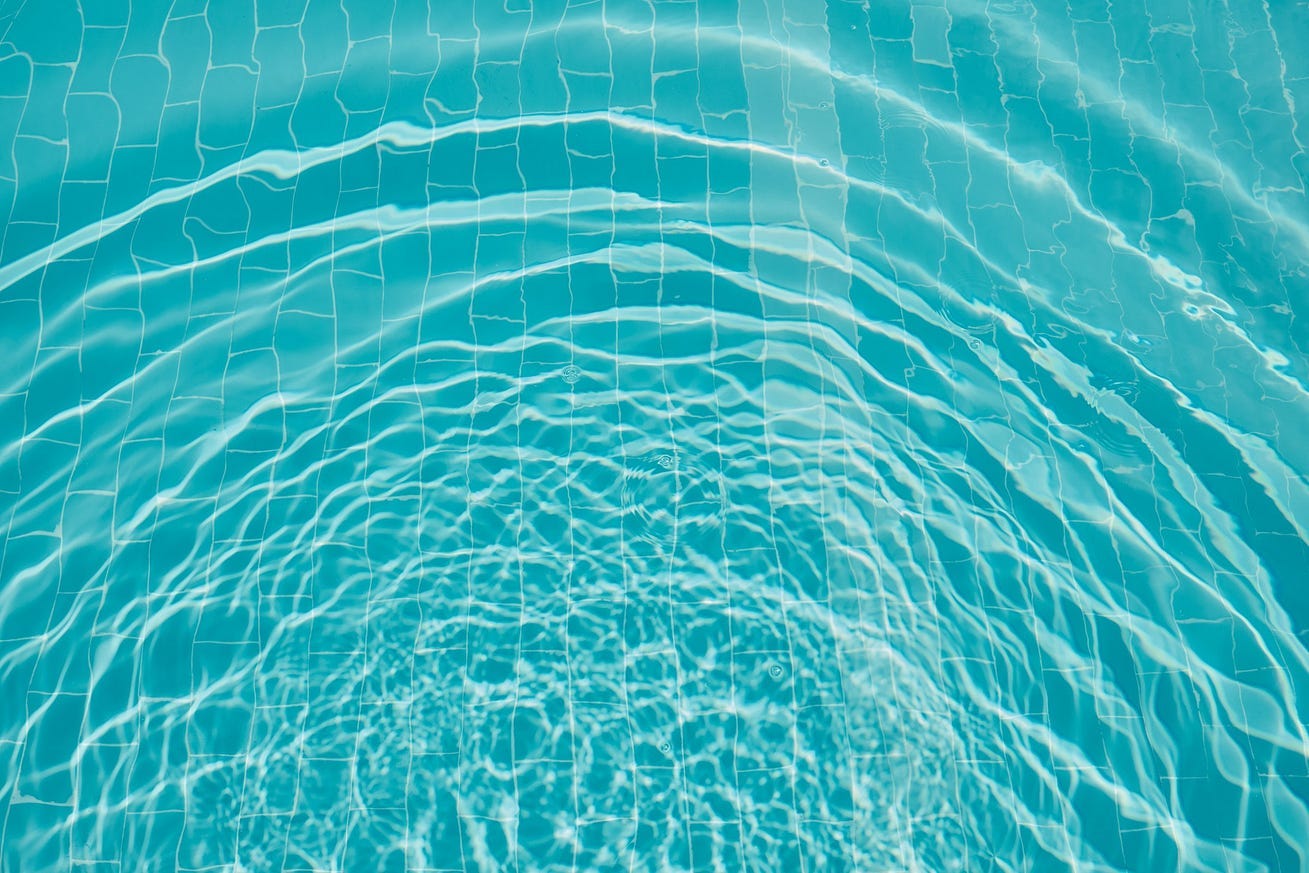 blue green water reflects sunlight in concentric patterns blue green water reflects sunlight in concentric patterns