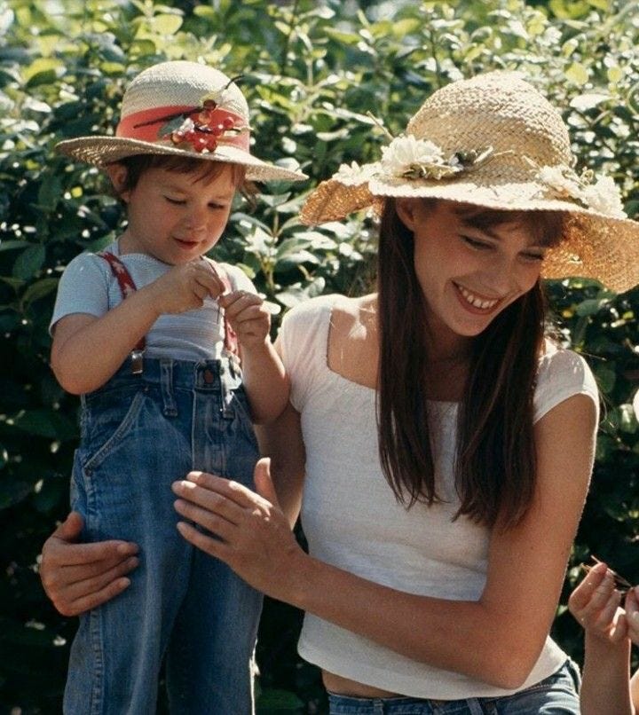 This may contain: two girls and a boy are standing in front of some bushes with straw hats on their heads This may contain: two girls and a boy are standing in front of some bushes with straw hats on their heads