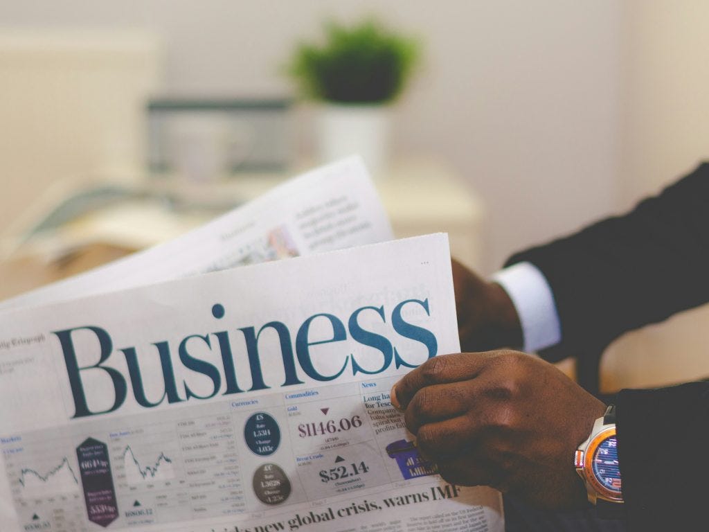 Person reading a business paper as a report from digital bank Zopa and Juniper Research finds that AI is transforming the banking industry, but the expected benefits and savings come at great human cost with the impact on finance jobs.