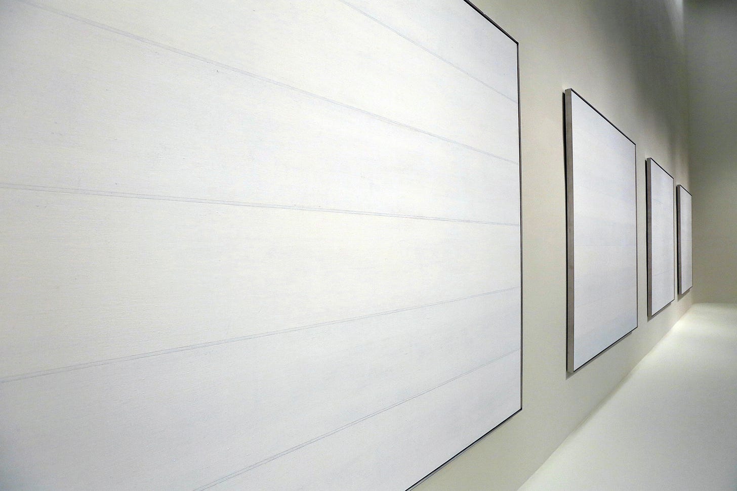 A series of square white and grey paintings by Agnes Martin A series of square white and grey paintings by Agnes Martin
