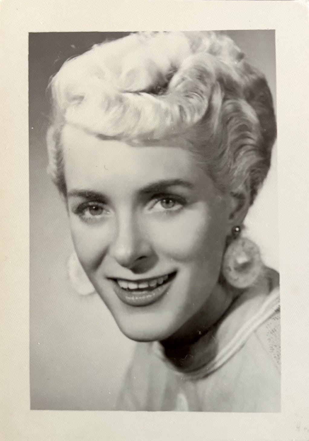 vintage photo of glamorous smiling woman with short blonde hair