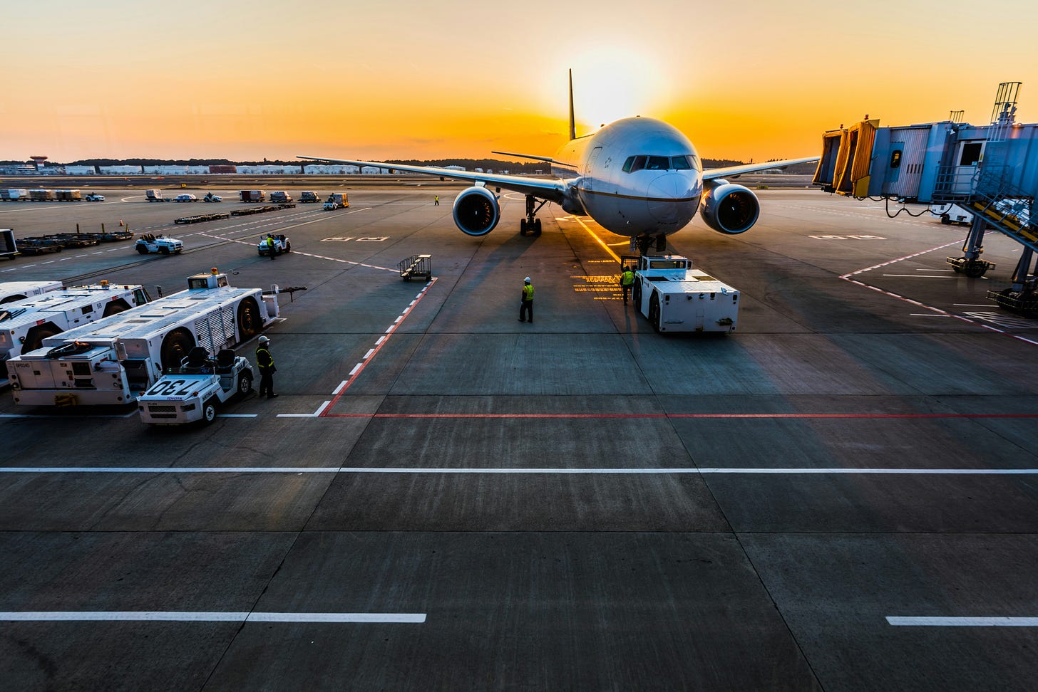 sunset over a terminal with a plane