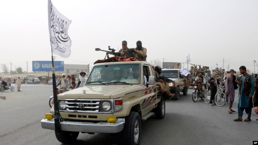 Taliban fighters patrol on the road during a celebration marking the second anniversary of the withdrawal of U.S.-led troops from Afghanistan, in Kandahar, south of Kabul, Afghanistan, Aug. 15, 2023.