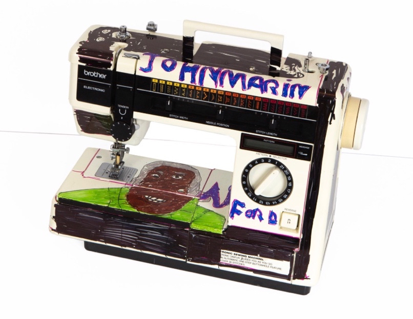 Brother sewing machine with text in red and blue with drawings in black, brown, gray of face in Sharpie markers.