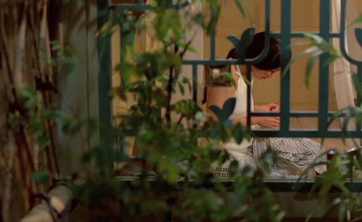 This may contain: a man in a hat is talking on his cell phone while looking out the window