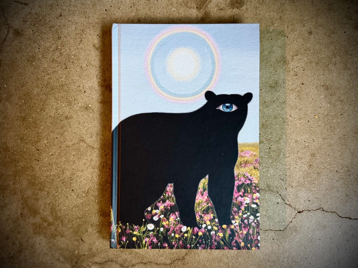 Cover of Dark Mountain 29, featuring illustration of a cyclops bear in a field of flowers