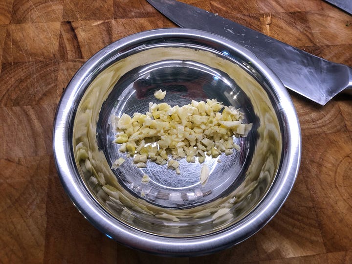 A gallery of four images. 1: Sausages that have had their casings removed 2: Chopped rapini in a colander. It is wet from rinsng. 3: A bowl of grated Parmesan cheese beside the grater and a hunk of cheese 4: Minced garlic in a small prep bowl