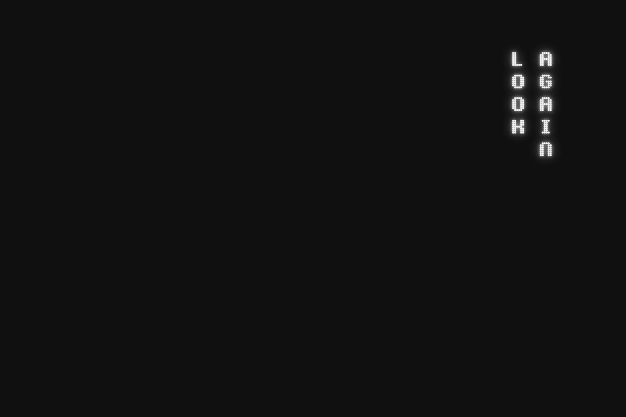 Graphic featuring the words "Look Again" in a vertical, two-column typographic layout on the right. The text is set against a solid black background, with the left two-thirds of the image remaining as open negative space.