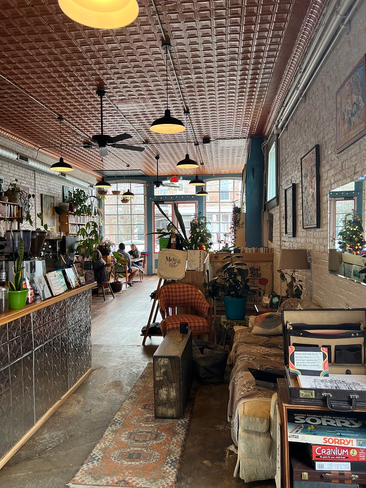 Left: The outside of Mickey's, showing an old stone building with tall green doors and lots of windows. Right: The inside of Mickey's, showing lots of mismatched tables and chairs and bookshelves everywhere. 