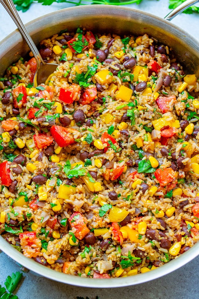 Mexican Rice, Beans, and Quinoa Medley in a deep skillet with a fork sticking out. Mexican Rice, Beans, and Quinoa Medley in a deep skillet with a fork sticking out.