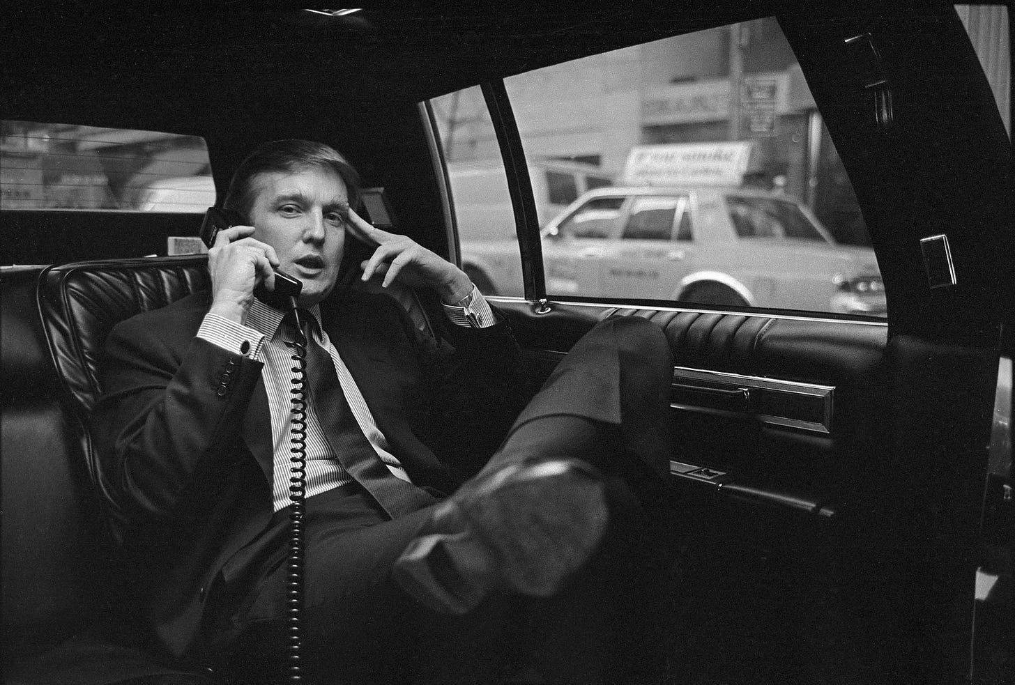 Donald Trump on the phone in his car after announcing plans for West Side development in Midtown Manhattan, New York, November 18, 1985. Donald Trump on the phone in his car after announcing plans for West Side development in Midtown Manhattan, New York, November 18, 1985.