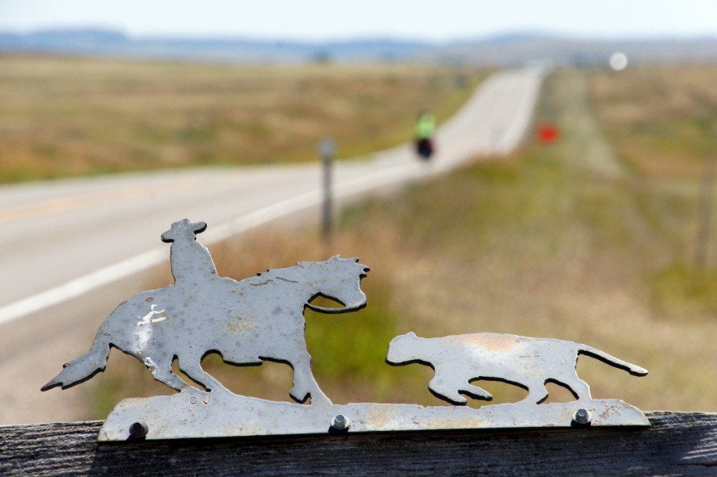 Mailbox ornamentation and Chelsea receding into the plains behind on her steed.
