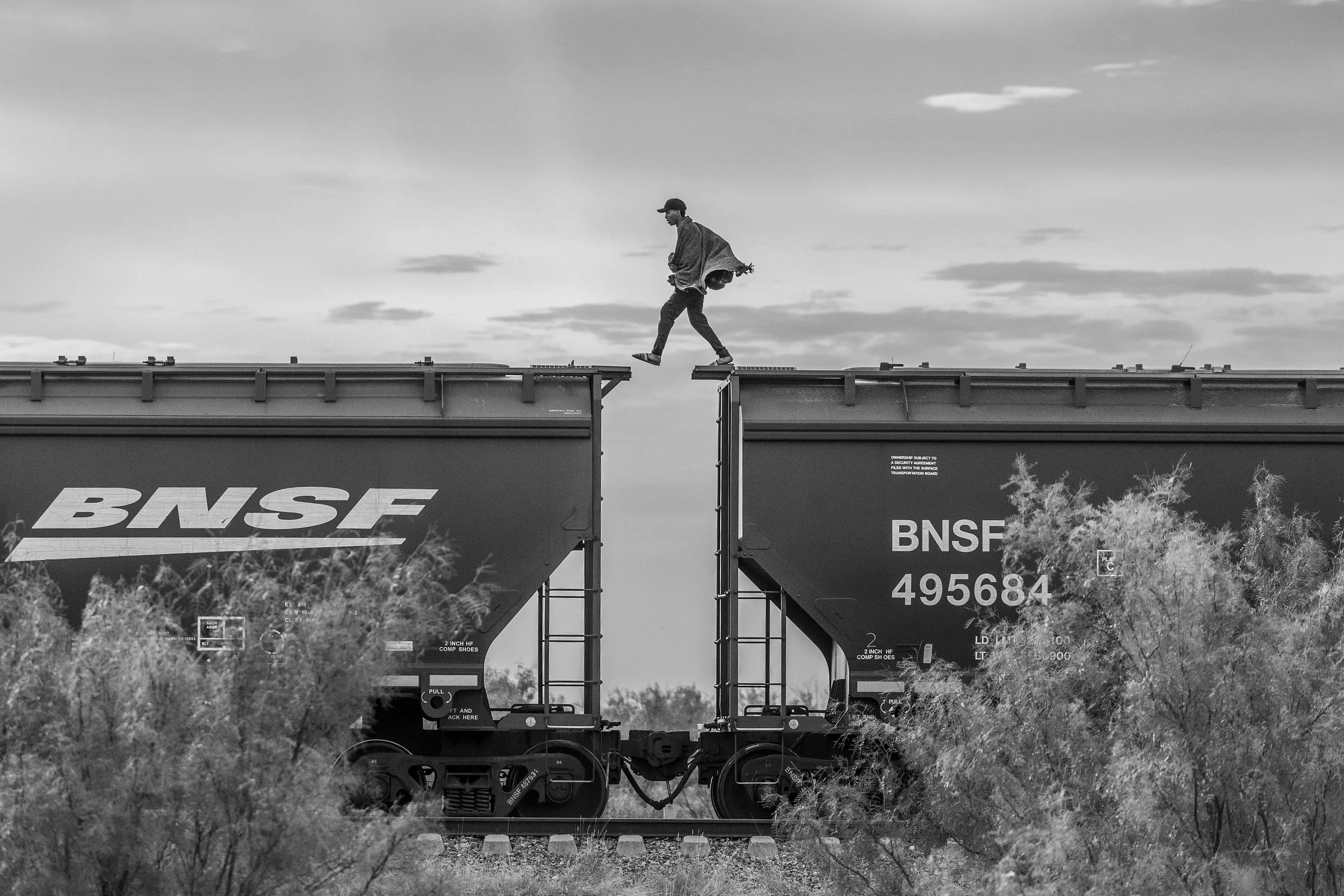 The walker. A migrant walks atop a parked freight train known as The Beast on the outskirts of Piedras Negras, October 8, 2023 © Alejandro Cegarra