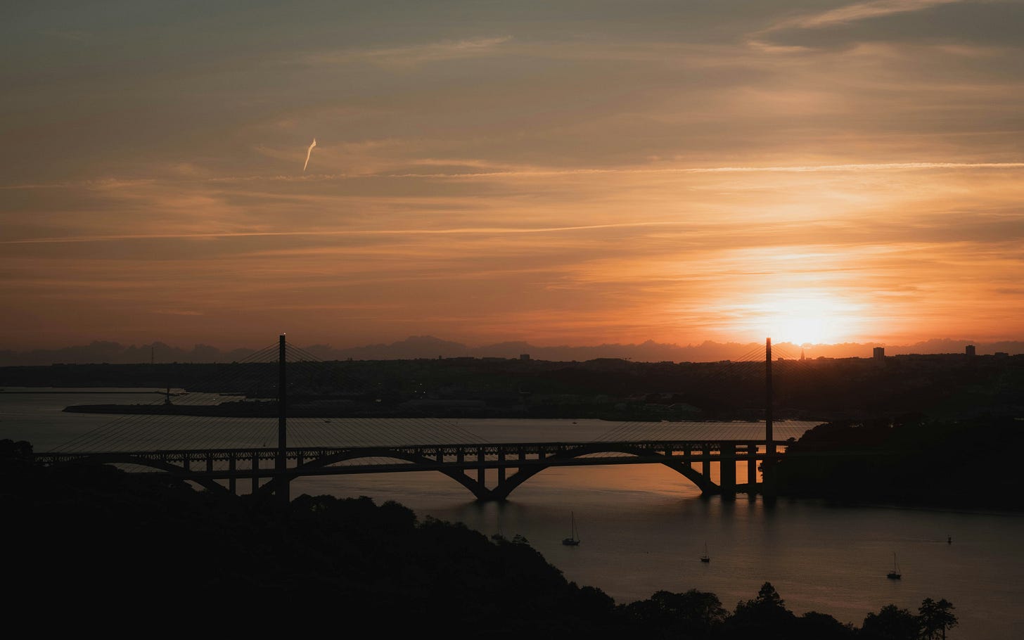 A wide bridge stretches across a river at sunset, silhouetted against an orange and gold sky. The scene evokes reflection, transition, and connection — a visual metaphor for building bridges between past struggles and new ways of understanding. A wide bridge stretches across a river at sunset, silhouetted against an orange and gold sky. The scene evokes reflection, transition, and connection — a visual metaphor for building bridges between past struggles and new ways of understanding.