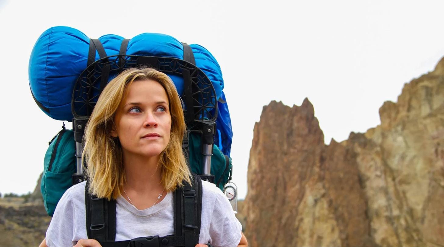 Scene from Wild featuring a solo female backpacker hiking along a remote trail. Scene from Wild featuring a solo female backpacker hiking along a remote trail.