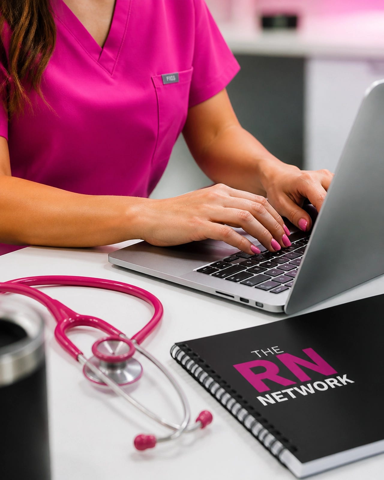 Close up of a nurse typing on a laptop with a pink stethoscope nearby, symbolizing the transition to digital health. Close up of a nurse typing on a laptop with a pink stethoscope nearby, symbolizing the transition to digital health.