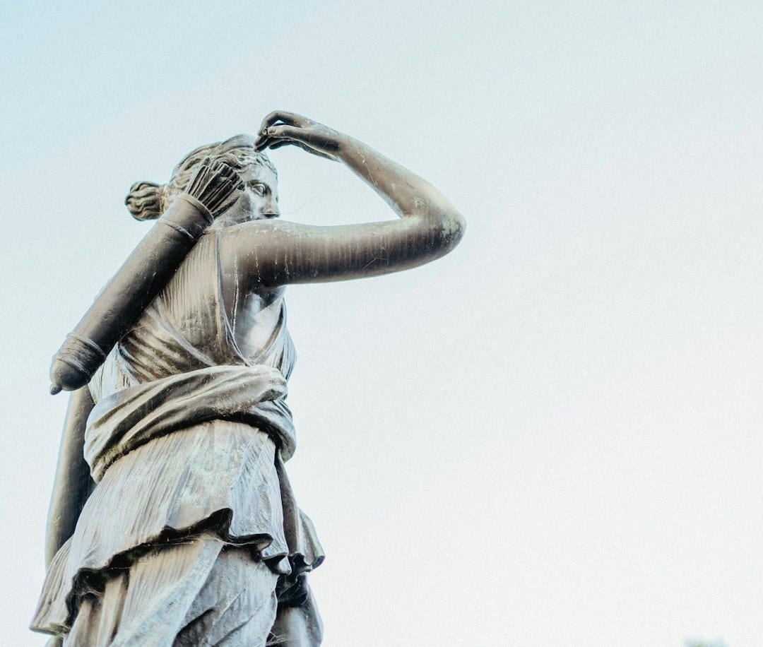 a statue of a woman holding her hands to her head a statue of a woman holding her hands to her head