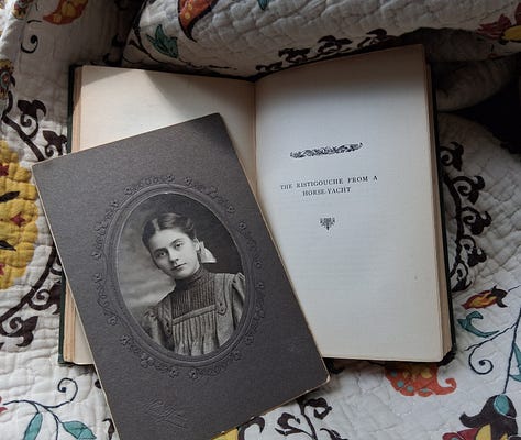 A spread of vintage books opened to reveal pressed four leaf clovers