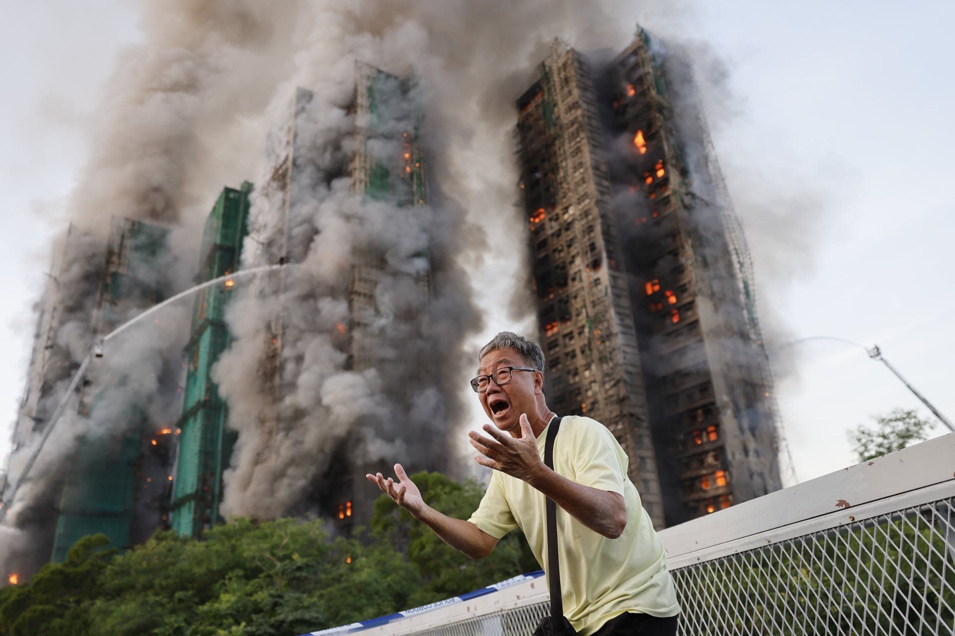 Mr Wong cries out in anguish as fire engulfs the Tai Po housing complex in Hong Kong that he calls home. Moments earlier, he exchanged final words over the phone with his wife, who was among the 168 victims trapped inside. 26 November 2025. © Tyrone Siu Mr Wong cries out in anguish as fire engulfs the Tai Po housing complex in Hong Kong that he calls home. Moments earlier, he exchanged final words over the phone with his wife, who was among the 168 victims trapped inside. 26 November 2025. © Tyrone Siu