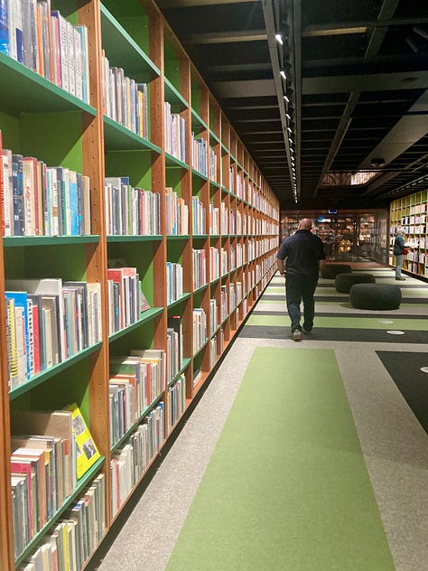 A series of nine photos inside the new library at MONA art museum shows shelves of books, reading lounges, cheeky covers, artist books, globes and more.