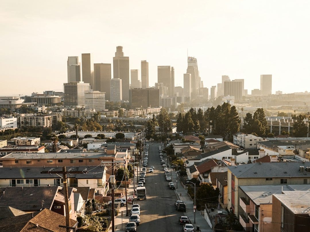 cars parked on roadside in front of houses at daytime cars parked on roadside in front of houses at daytime