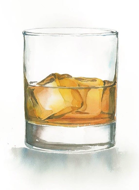 This may contain: a glass filled with ice sitting on top of a table