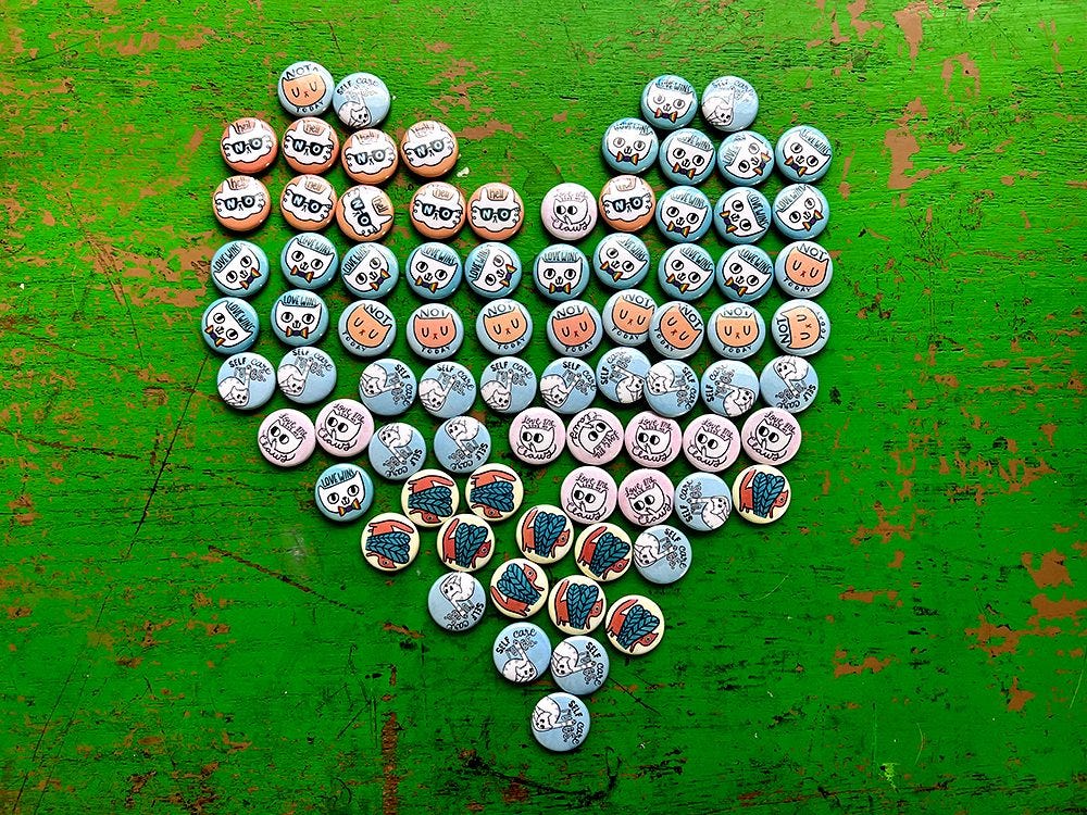 Pinback buttons arranged in a heart shape