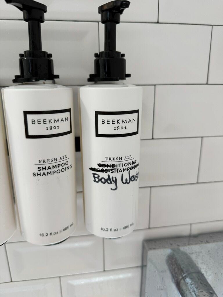 Shampoo photos and "conditioner" Bottles in hotel showers. superior "conditioner" The words in the bottle have been crossed out with a black marker and someone has written "body wash" But on the bottle. Shampoo photos and "conditioner" Bottles in hotel showers. superior "conditioner" The words in the bottle have been crossed out with a black marker and someone has written "body wash" But on the bottle.