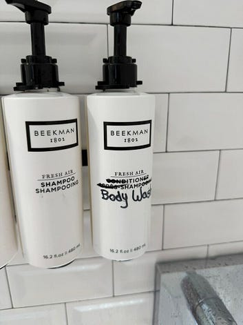 Photo of shampoo and "conditioner" bottles in a hotel shower. On the "conditioner" bottle, the words have been crossed out with black Sharpie and someone has written "Body wash" on the bottle instead. Photo of shampoo and "conditioner" bottles in a hotel shower. On the "conditioner" bottle, the words have been crossed out with black Sharpie and someone has written "Body wash" on the bottle instead.