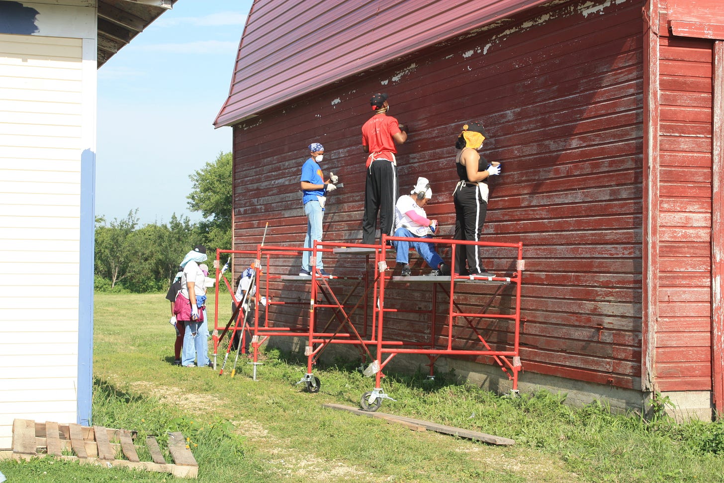 students painting building