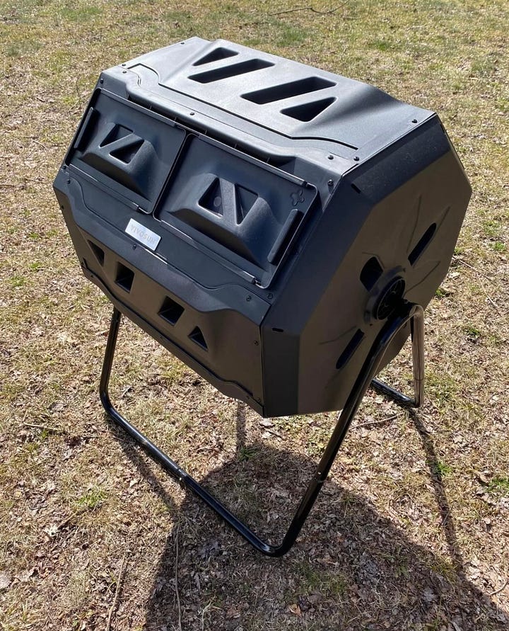 The contents of a tumbling composter and a black tumbling composter.