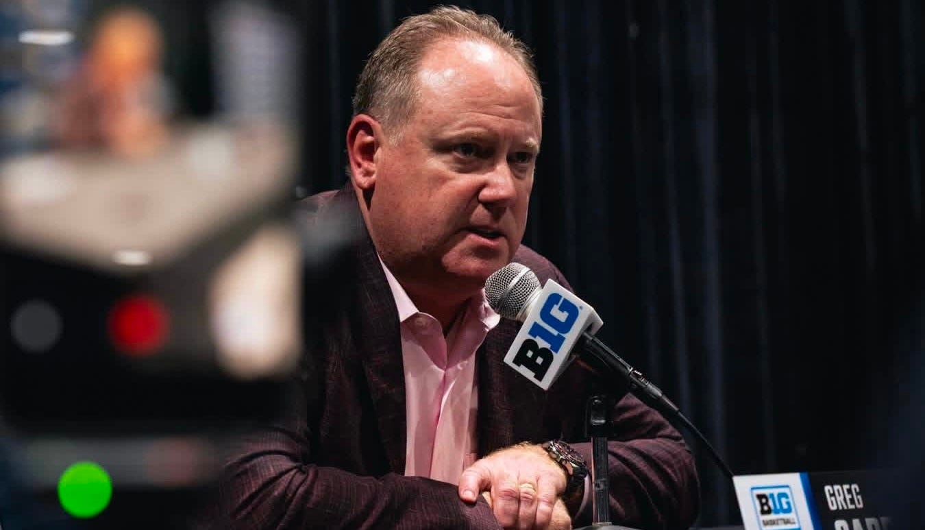 Wisconsin basketball coach Greg Gard speaks into a microphone during Big Ten Media Days.