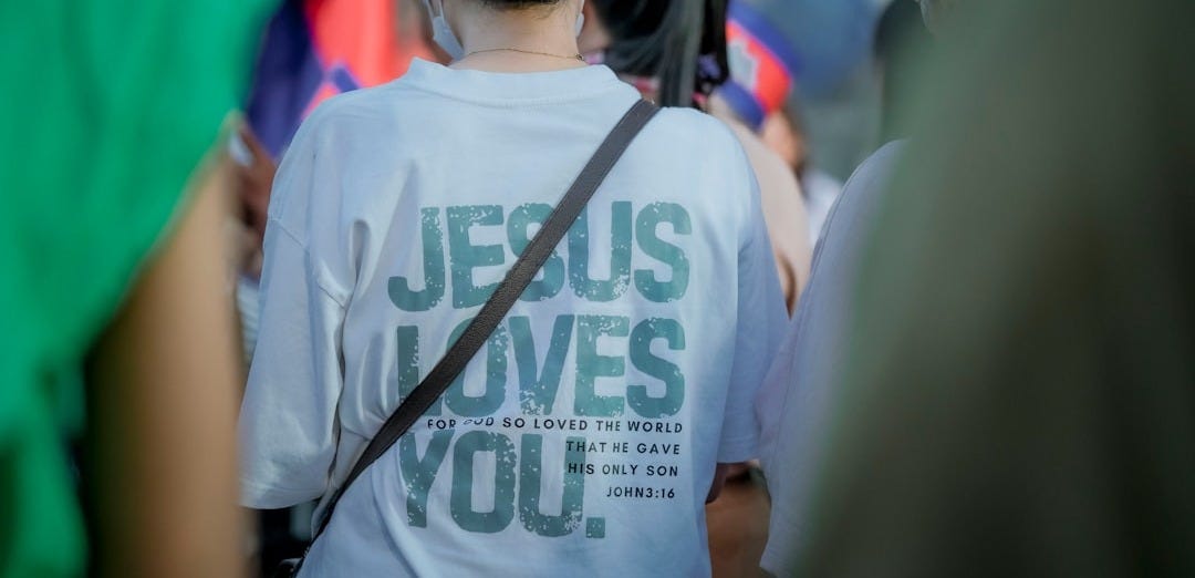 Woman wearing a t-shirt with jesus loves you text