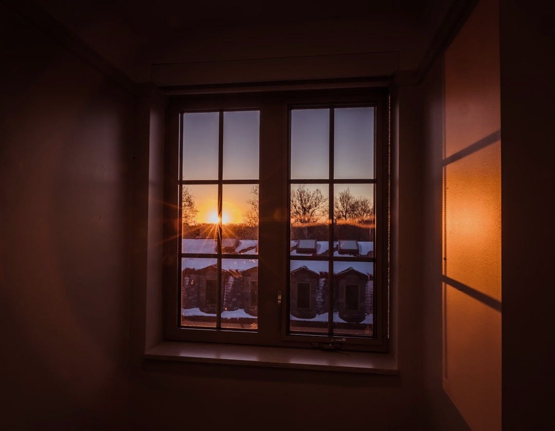 a window with a view of a snowy landscape