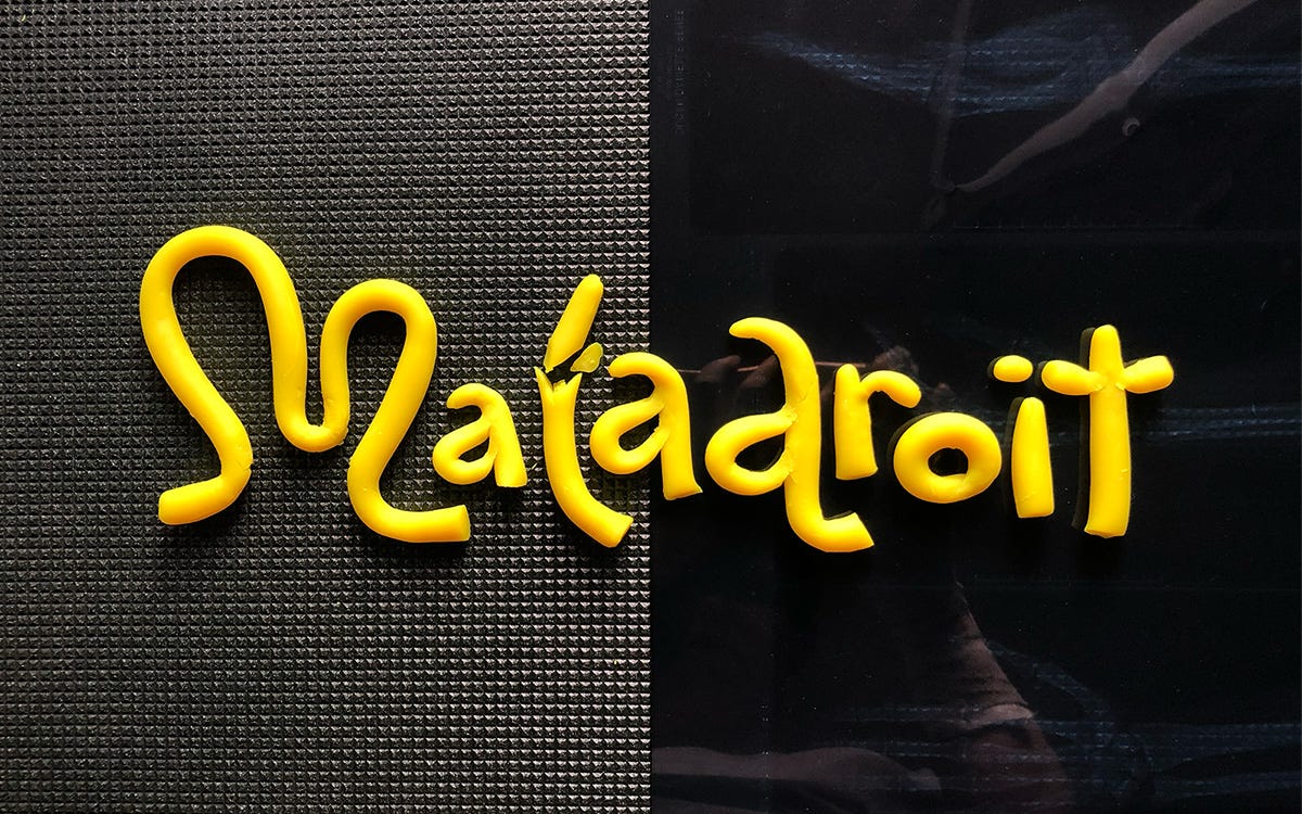 Clay molded into the world Maladroit on a mat and a an original xray