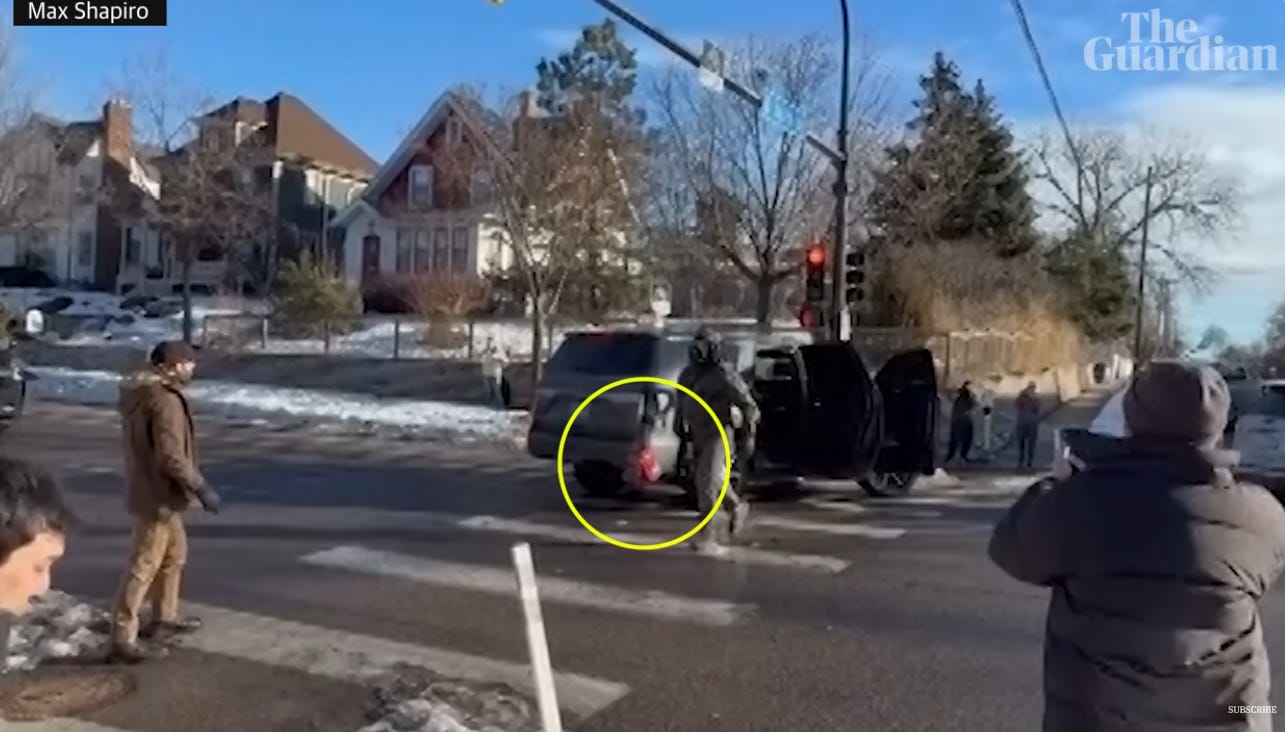 Screenshot of Guardian video showing Alex Pretti, in brown jacket, stocking cap, and gloves, standing about 15 feet away from the ICE rental SUV whose taillight was broken when Pretti kicked it (separate video shows the actual kick). The video producer has helpfully circled the damaged taillight assembly, which is hanging by wires from the rear of the vehicle. An ICE agent can be seen walking from the SUV toward Pretti; shortly after, the goon tackled Pretti. Other agents then fired pepper balls and tear gas at the crowd gathered at the intersection. Screenshot of Guardian video showing Alex Pretti, in brown jacket, stocking cap, and gloves, standing about 15 feet away from the ICE rental SUV whose taillight was broken when Pretti kicked it (separate video shows the actual kick). The video producer has helpfully circled the damaged taillight assembly, which is hanging by wires from the rear of the vehicle. An ICE agent can be seen walking from the SUV toward Pretti; shortly after, the goon tackled Pretti. Other agents then fired pepper balls and tear gas at the crowd gathered at the intersection.