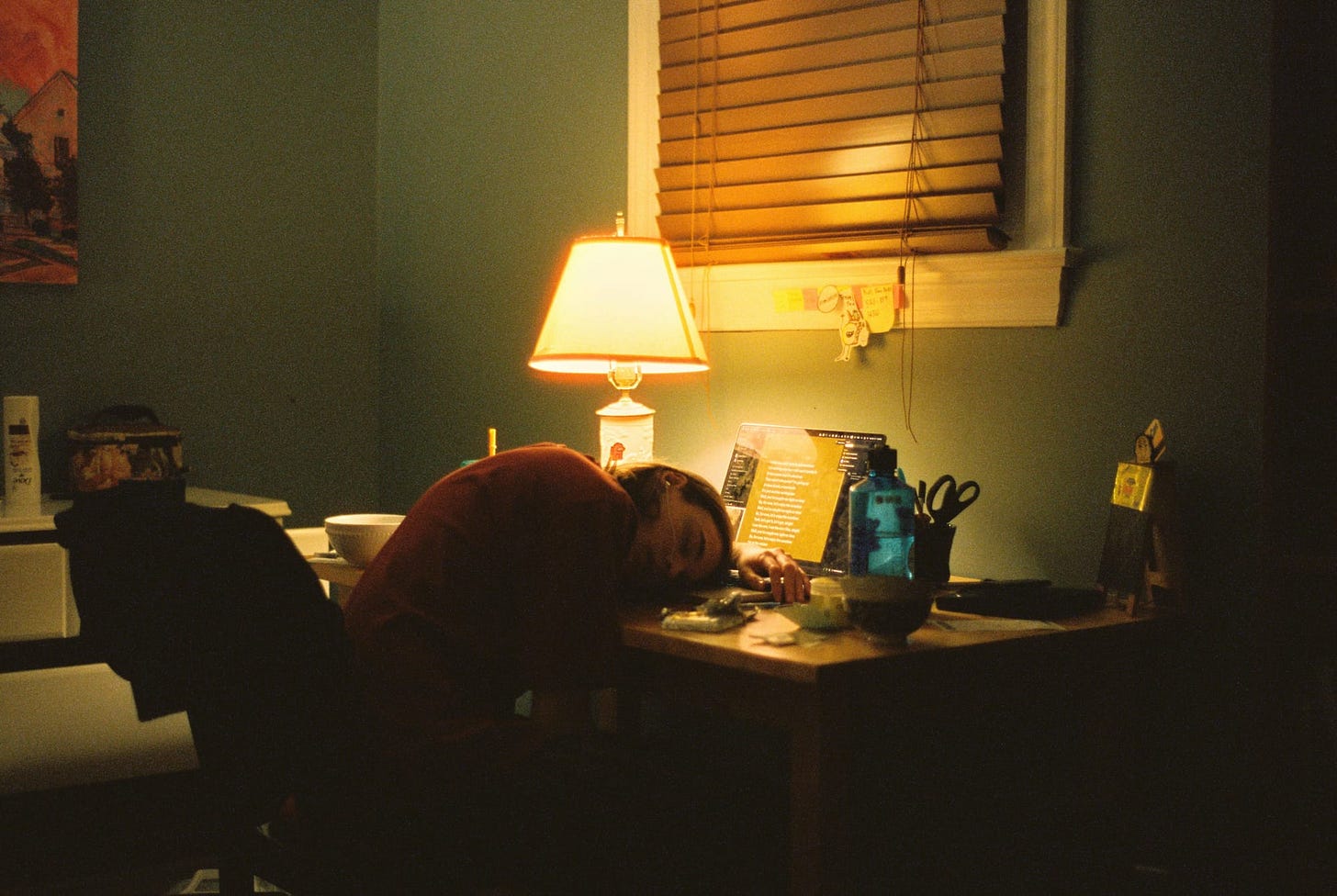 Woman slumped over her computer, asleep at her desk Woman slumped over her computer, asleep at her desk