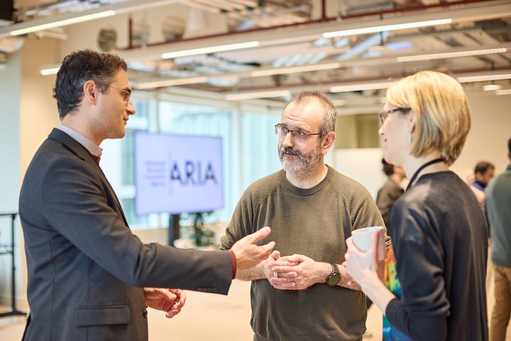 Three women speaking and smiling with ARIA lanyard (left photo), two men and a women speaking with an ARIA logo in the background (right hand side)