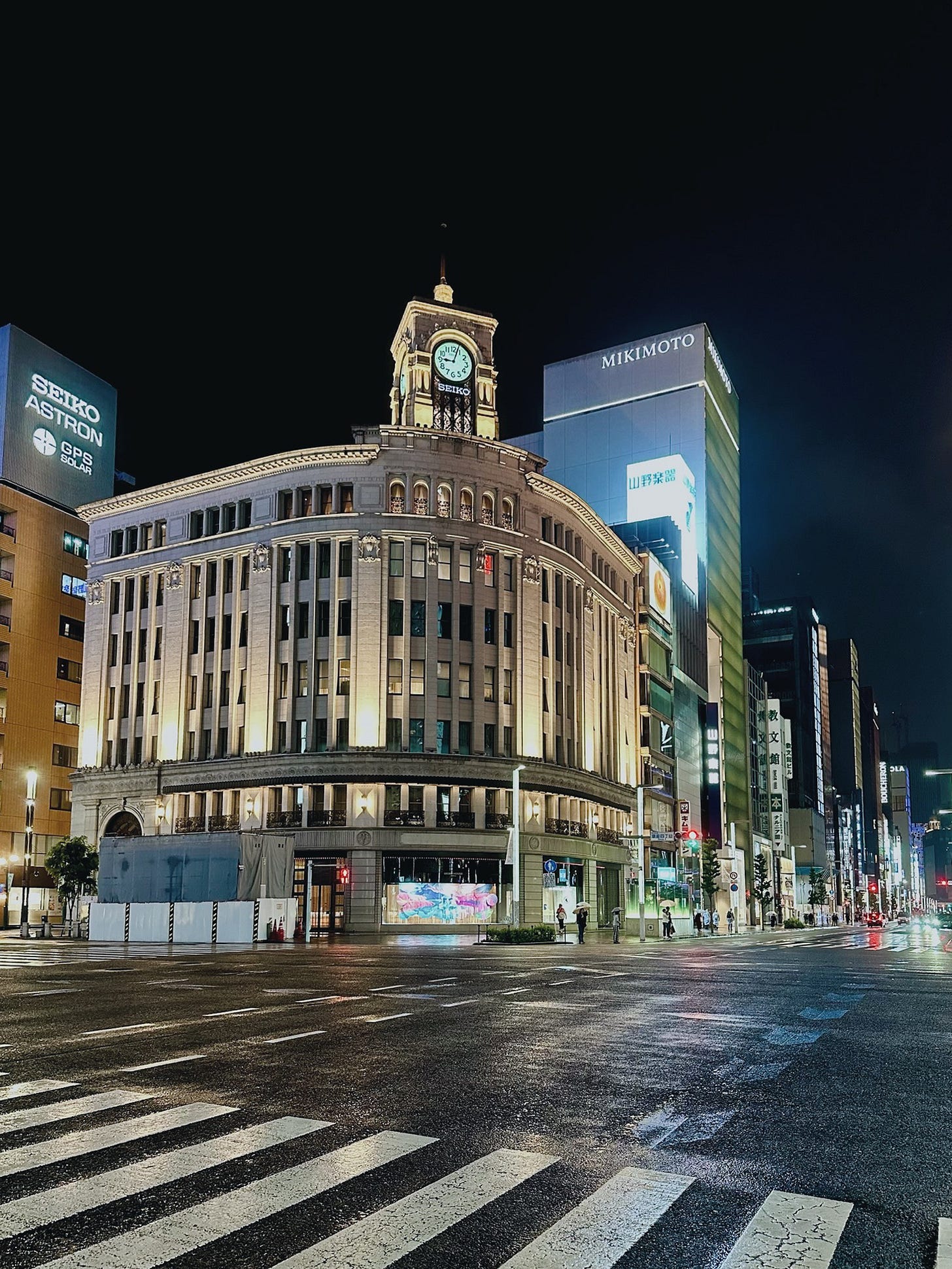 Refined night view of the Seiko building and clock tower with empty streets. Refined night view of the Seiko building and clock tower with empty streets.