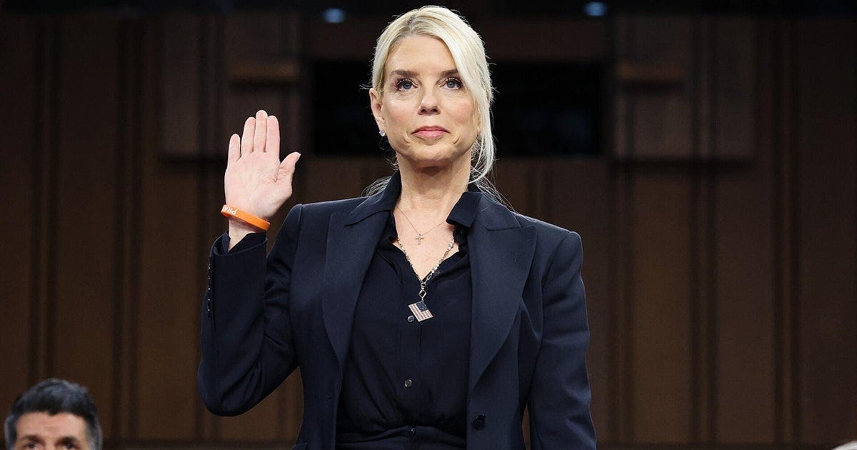 A person in a suit holding her hand up

AI-generated content may be incorrect.