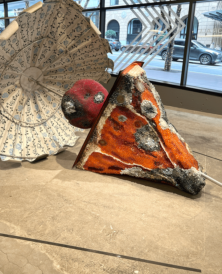 fabric art in brown cream and pink, sculpture of a rotting orange slice
