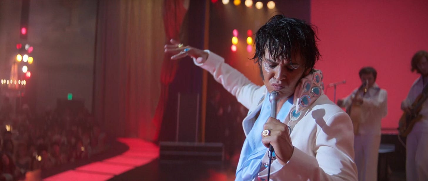 A still from Baz Luhrmann's Elvis. Elvis Presley (Austin Butler) stands onstage at the Las Vegas International hotel, in the midst of an addled and distressed performance of "Suspicious Minds."