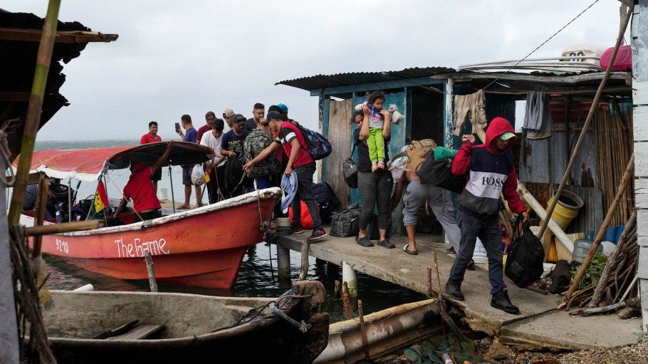 Venezuelan migrants arrive at Panama's Caribbean coastal island of in Gardi Sugdub, Sunday, Feb. 23, 2025, to board boats to Colombia after giving up hopes of reaching the U.S. while in southern Mexico as President Trump cracks down on migration. (AP Photo/Matias Delacroix)