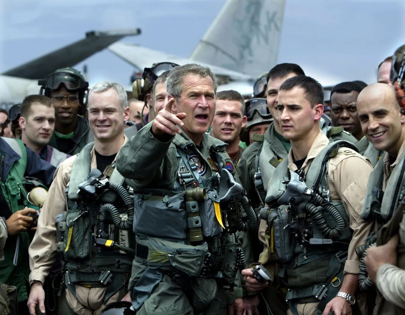 President George W. Bush meets with crew members on the deck of the USS Abraham Lincoln.